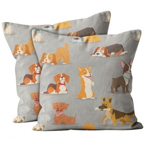May include: Two gray throw pillows with a repeating pattern of cartoon dogs in various poses and colors. The dogs are on a light gray background.
