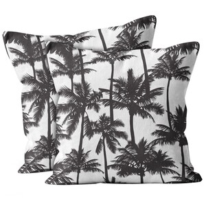 May include: Two square throw pillows with a black and white palm tree pattern. The pillows feature a repeating design of stylized palm trees against a white background. The pillows are likely made of a soft fabric and are suitable for home decor.
