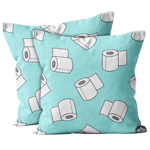 May include: Two turquoise blue pillowcases with a white and gray repeating pattern of toilet paper rolls.