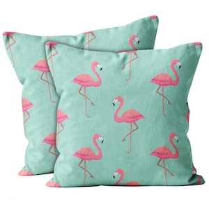 May include: Two turquoise blue pillowcases with a pink flamingo pattern. The pillowcases are made of a soft, comfortable fabric and feature a repeating pattern of pink flamingos on a turquoise blue background.