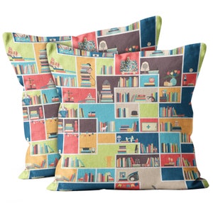 May include: Two colorful throw pillows with a bookshelf pattern. The pillows feature a variety of colors, including red, yellow, blue, green, and brown. The bookshelf pattern includes books, a scale, a trophy, a globe, and other decorative items.