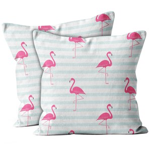 May include: Two decorative pillowcases with a light blue and white striped background and a pink flamingo pattern.