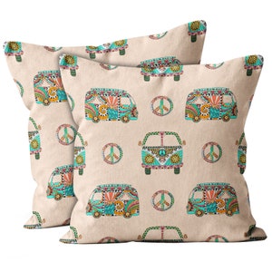 May include: Two square throw pillows with a repeating pattern of colorful, decorated vans and peace signs on a beige background. The vans are teal, orange, and yellow, with intricate floral and geometric designs.