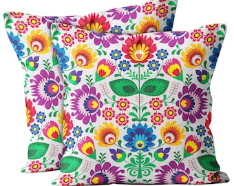 May include: Two decorative throw pillows with a colorful floral pattern. The pillows feature a white background with bright red, yellow, blue, green, and purple flowers.