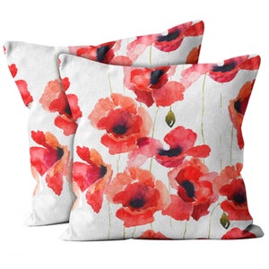 May include: Two white pillowcases with a watercolor pattern of red poppies. The pillows are made of a soft, textured fabric.