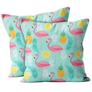 May include: Two turquoise blue throw pillows with a tropical pattern featuring pink flamingos, pineapples, and lemons.
