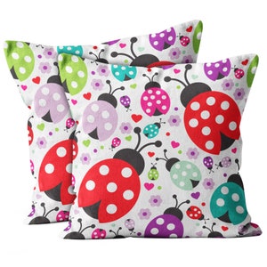 May include: Two white pillowcases with a colorful ladybug pattern. The pillowcases feature red, pink, purple, green, and blue ladybugs with white polka dots on a white background with small pink hearts and flowers.
