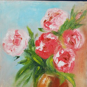 May include: A painting of a bouquet of pink and red peonies in a brown vase. The flowers are arranged in a loose, natural style, and the background is a soft blue.