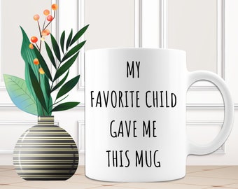 May include: White ceramic mug with black text that reads "My Favorite Child Gave Me This Mug".
