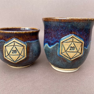 Ceramic Mug with D20 Emblem, with several glaze options.
