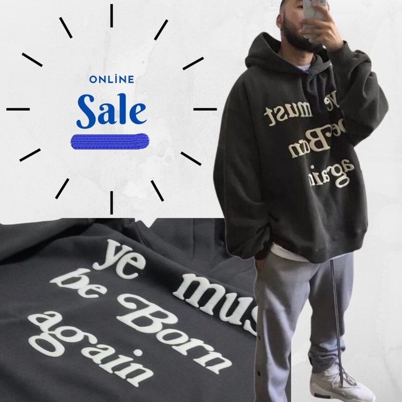 May include: Black hoodie with the text "Ye must be born again" in white lettering. The hoodie is oversized and has a drawstring hood.