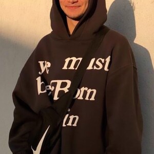May include: A black hoodie with a white graphic that says "Ye must be born again".