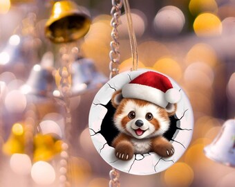 Adorable 3D red panda with red Santa hat ornament. Panda looks like he is breaking through ornament. Double sided.