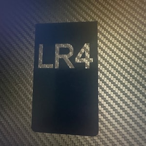 May include: A black square sticker with the text "LR4" in white lettering.