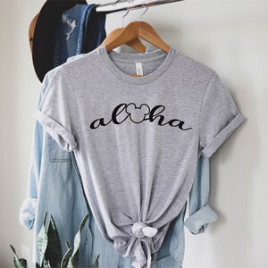 May include: Gray t-shirt with a black Mickey Mouse head and the word "Aloha" written in a cursive font.