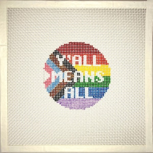 May include: A white canvas with a colorful circle in the center. The circle is made up of different colors, including red, orange, yellow, green, blue, and purple. The text "Y'all means all" is written in white letters on the circle.