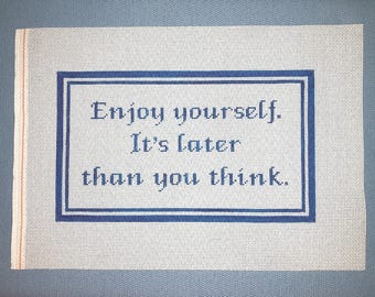 May include: White canvas with a blue border and the text "Enjoy yourself. It's later than you think."