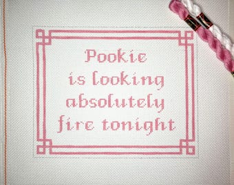 May include: Pink cross-stitch embroidery with a white background. The embroidery says "Pookie is looking absolutely fire tonight".