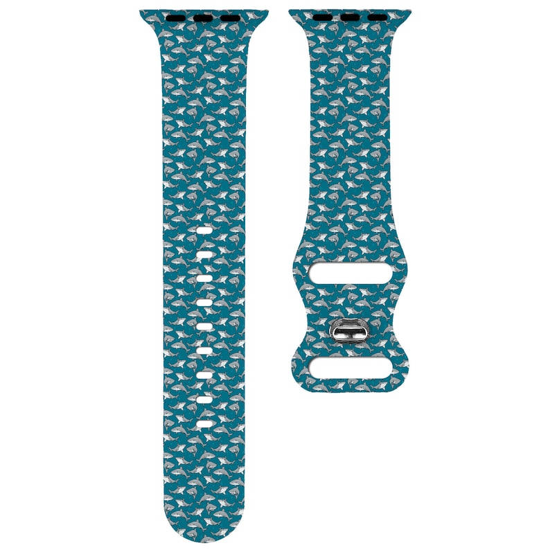 May include: A teal blue Apple Watch band with a white shark pattern.