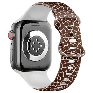 May include: A white and brown patterned watch strap with a giraffe print. The strap is made of silicone and is compatible with Apple Watch.