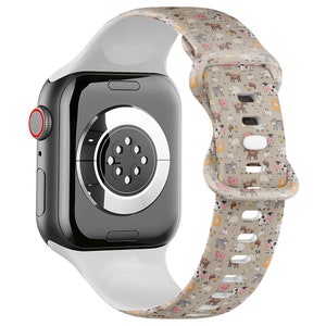 May include: White silicone Apple Watch band with a farm animal print. The band has a white buckle and is compatible with Apple Watch Series 4 and later.