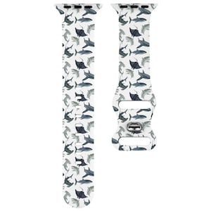 May include: White Apple Watch band featuring a pattern of blue and grey sharks and manta rays.