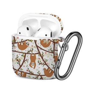 May include: White Airpods case with a sloth pattern and a silver carabiner clip. The case has a white background with brown sloths hanging from branches with pink flowers and green leaves.