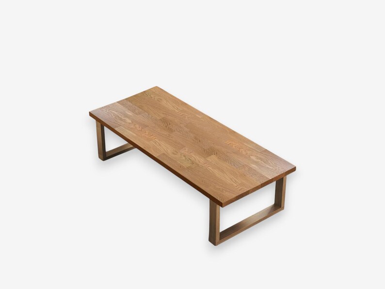 May include: A rectangular wooden coffee table with a light brown finish. The table has a simple design with a flat top and four rectangular legs. The table is approximately 48 inches long and 24 inches wide.