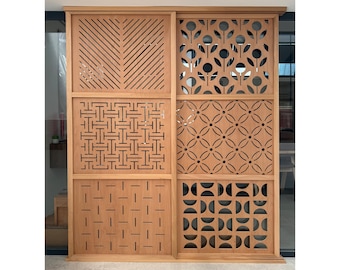 May include: A light brown wooden room divider featuring six distinct panels with varied laser-cut patterns. The left side displays diagonal lines, a geometric grid, and horizontal dashes, while the right side shows floral, circular, and semi-circular motifs.