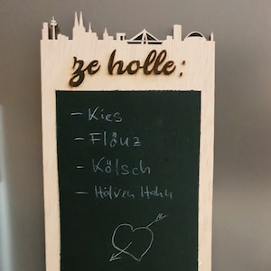 Shopping list board with Cologne skyline as a fridge magnet