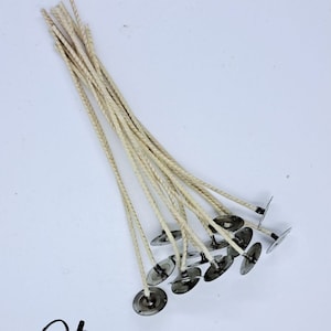 May include: A pack of 10, 6-inch, natural cotton candle wicks with metal tabs. The wicks are bundled together and the metal tabs are visible.
