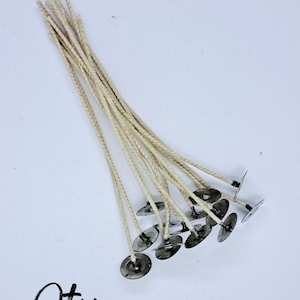 May include: A bundle of 10 white cotton candle wicks with metal tabs, each wick is 6 inches long. The label reads "CD-12 6" ".