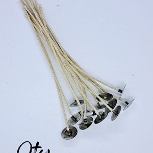 May include: A pack of 10 white cotton candle wicks with metal tabs, labeled "CD-14 6" ".