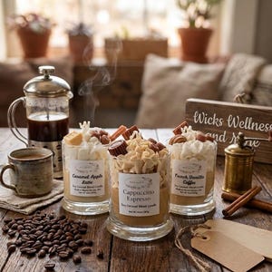 May include: Three glass candles topped with whipped wax and miniature chocolate decorations. Labels read Caramel Apple Latte, Cappuccino Espresso, and French Vanilla Coffee. Each candle contains 10 oz of soy coconut blend wax.