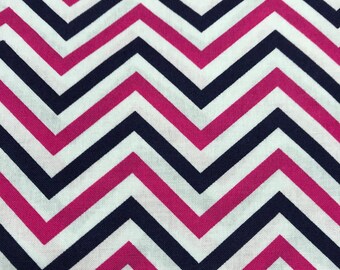 May include: White fabric with a chevron pattern in pink and navy blue.