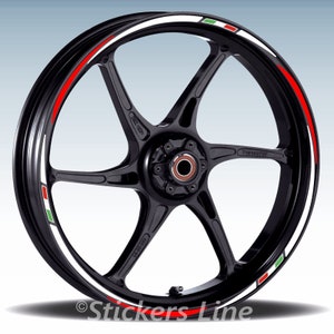 May include: A black motorcycle wheel rim with a white, red, and green stripe decal. The decal features the colors of the Italian flag.