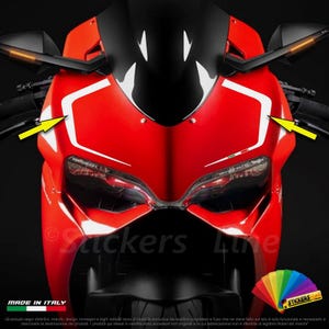 May include: A close-up of a red motorcycle fairing with white accent lines. The fairing has a black windscreen and side mirrors. The text "Stickers Line" and "MADE IN ITALY" are visible.