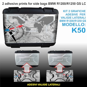 May include: Two adhesive prints for side bags, featuring a world map with a compass design. The prints are designed for BMW R1200/R1250 GS LC motorcycles. The text on the image reads "KIT 2 GRAFICHE ADESIVE PER VALIGIE LATERALI BMW R1200/R1250 GS MODELLO: K50".