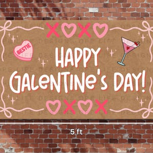 May include: A rectangular sign, 152 cm wide and 91 cm tall, with "Happy Galentine's Day!" in white and pink. It features pink hearts, XOXO symbols, and a cocktail illustration. Decorative elements are included.