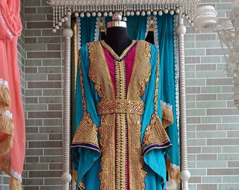 May include: A long, flowing blue and purple dress with gold embroidery and a pink sash. The dress has a high neckline and long sleeves with bell bottoms. The dress is decorated with intricate gold embroidery and sequins.
