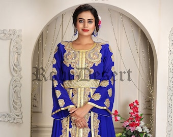 May include: A royal blue kaftan with gold embroidery and a gold belt. The kaftan has long sleeves and a flowing skirt.