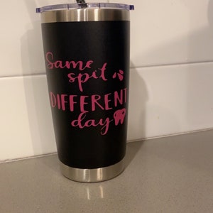 May include: Black stainless steel tumbler with a pink design that says "Same spit different day" with a pink tooth graphic.