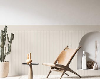 May include: A minimalist interior scene featuring a wooden chair with a tan leather seat, a small side table with a decorative object, and a potted cactus. The room has a neutral color palette with a white rug and wall.