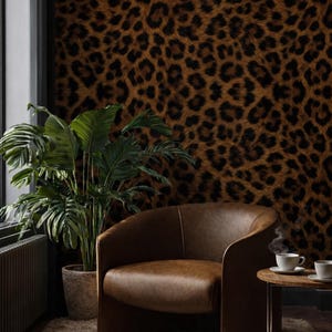 May include: A stylish living room with a brown leather armchair, a small side table with two cups of coffee, and a large potted plant. The wall is covered in a leopard print wallpaper, and the floor has a shaggy rug.
