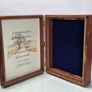 May include: A wooden display box with a hinged lid featuring a printed sympathy message that reads: In the fullness of time a life's journey ends. But love once shared continues to live. And beyond this day... that love prevails. With Sincere Sympathy.