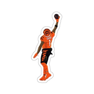May include: A digital illustration of an American football player wearing an orange and black uniform with the number "1" and the name "CHASE" on the back. The player is reaching up to catch a football.