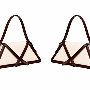 Peut inclure: Deux sacs &agrave; main cr&egrave;me avec un design triangulaire unique. Les sacs pr&eacute;sentent des bordures et des sangles marron fonc&eacute;, avec une seule poign&eacute;e. Les sacs ont une esth&eacute;tique minimaliste, adapt&eacute;e &agrave; diverses occasions.