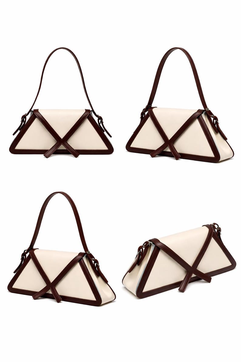 Peut inclure: Un sac &agrave; main cr&egrave;me avec une forme triangulaire unique. Le sac est orn&eacute; de bordures et de sangles marron fonc&eacute; qui se croisent sur le devant. La poign&eacute;e est &eacute;galement marron fonc&eacute;. Le sac est pr&eacute;sent&eacute; sous plusieurs angles.