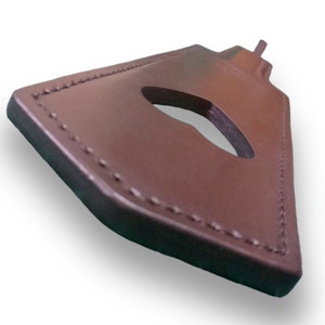May include: A brown leather key fob with a stitched edge and a keyhole cutout.