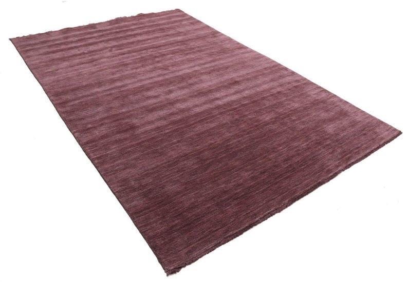 May include: A rectangular rug in a deep burgundy color. The rug has a textured, ribbed surface, with horizontal lines running across its length. The rug is set against a white background.